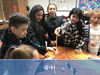 4-H children creating with dry spaghetti and marshmallows.