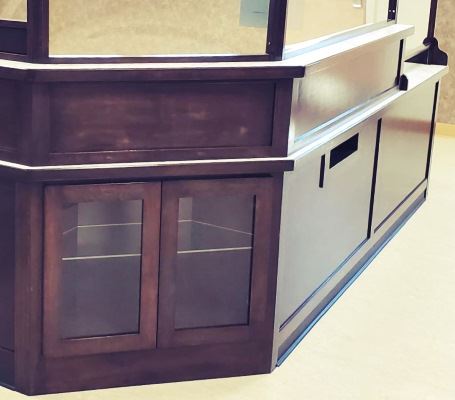 The desk has a small display case built in, and a book return slot.