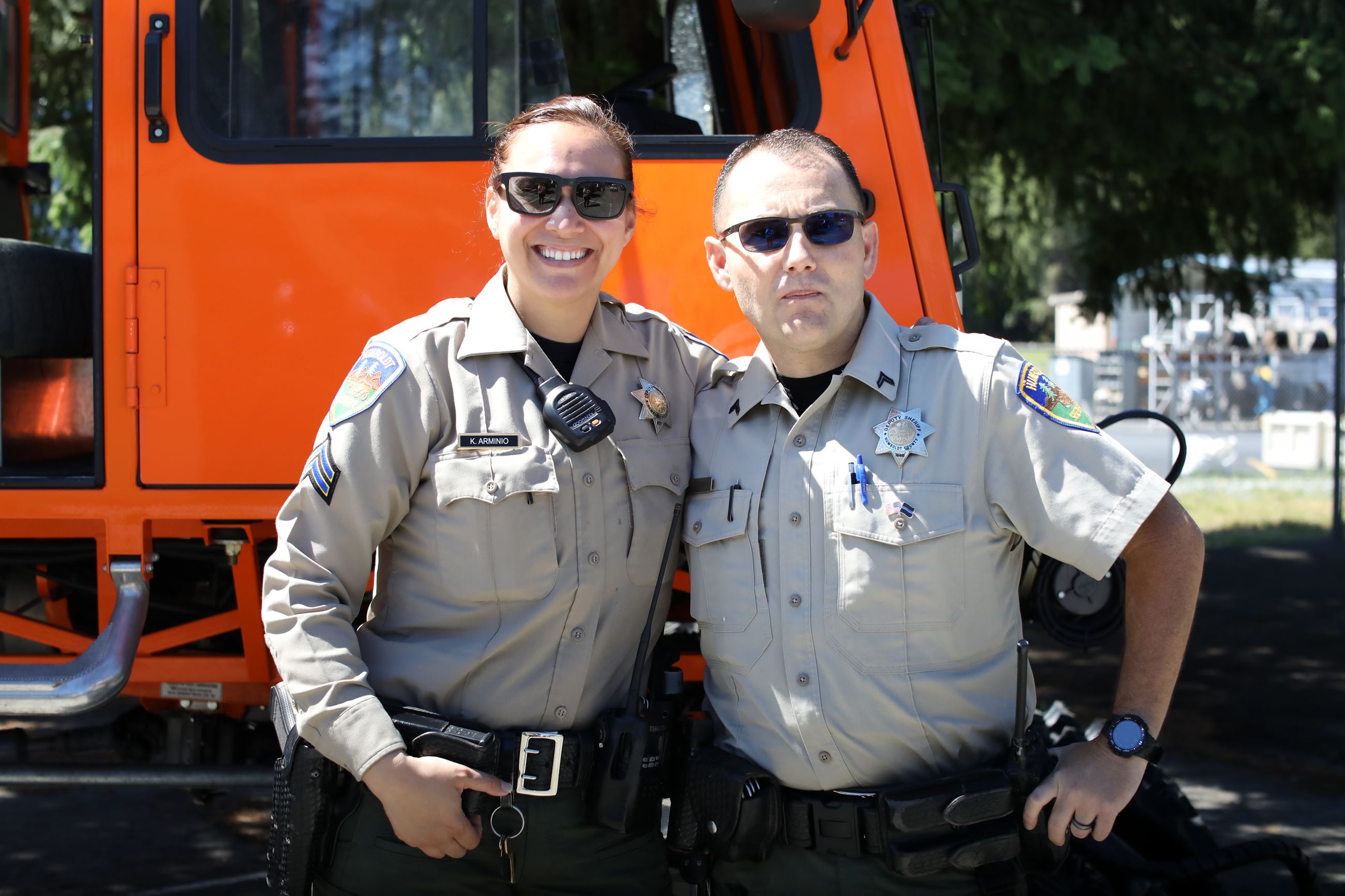 A female and male deputy in front of the Sno-Cat