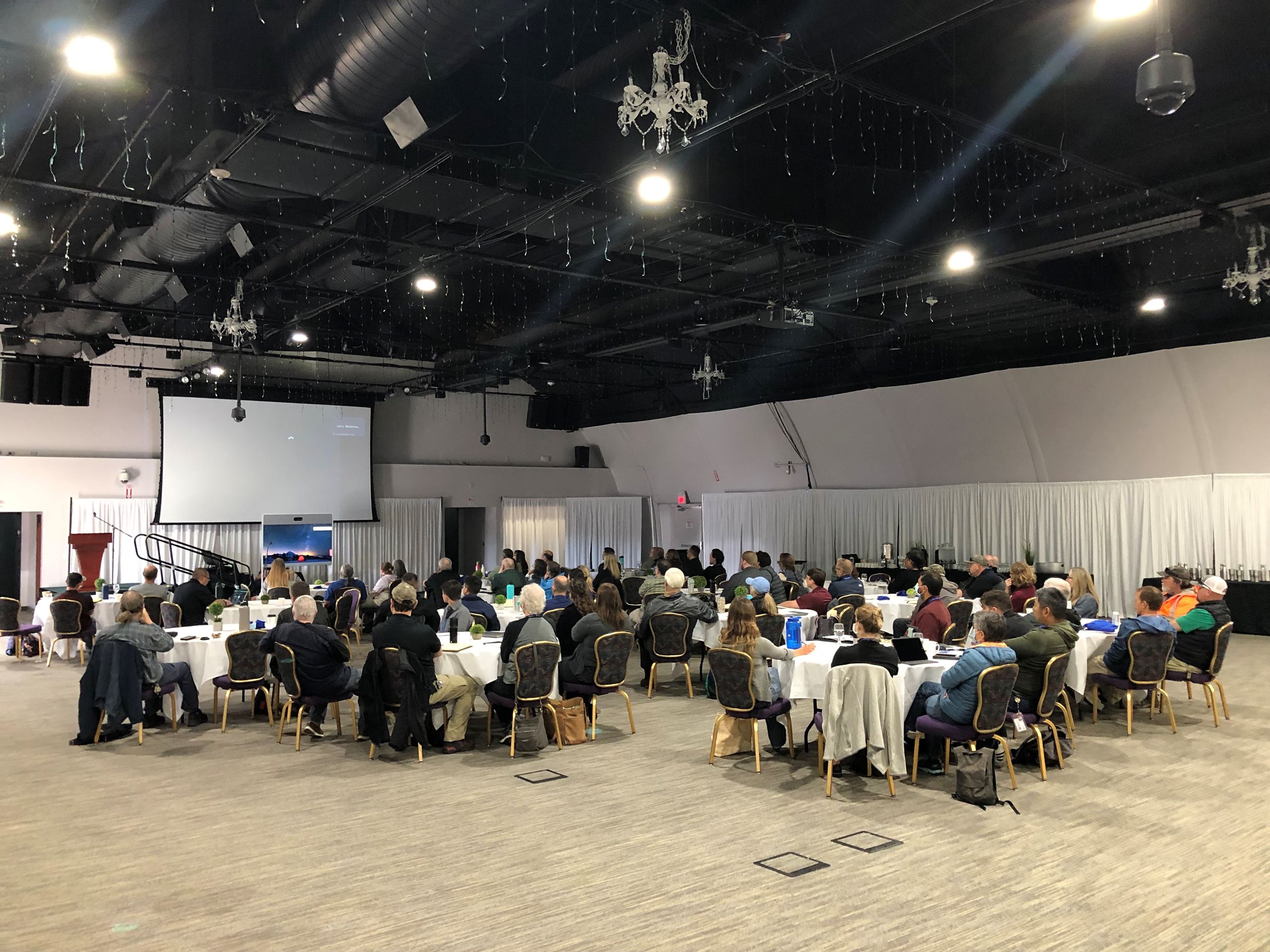 Dozens of individuals sit in a training