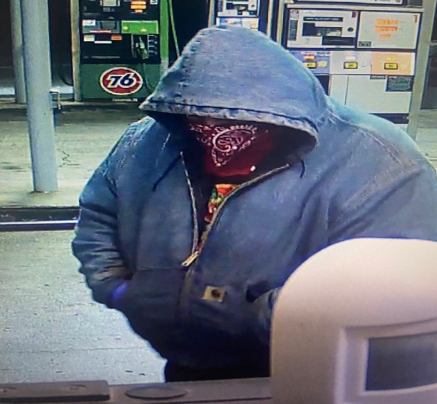 Robbery suspect described as a heavyset male last seen wearing a red bandana over his face. 