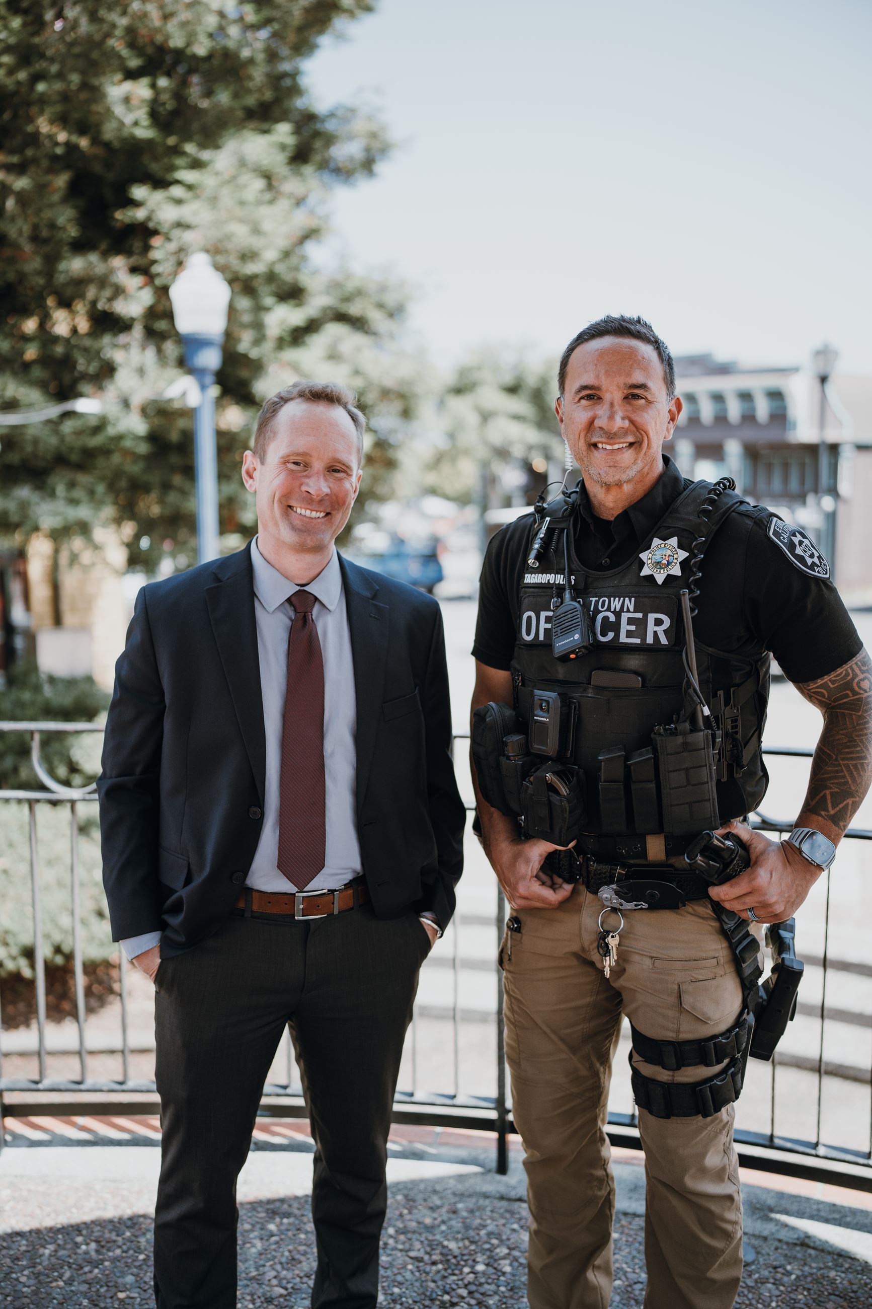 District Attorney staff member and Law Enforcement Office stand side by side and smile.