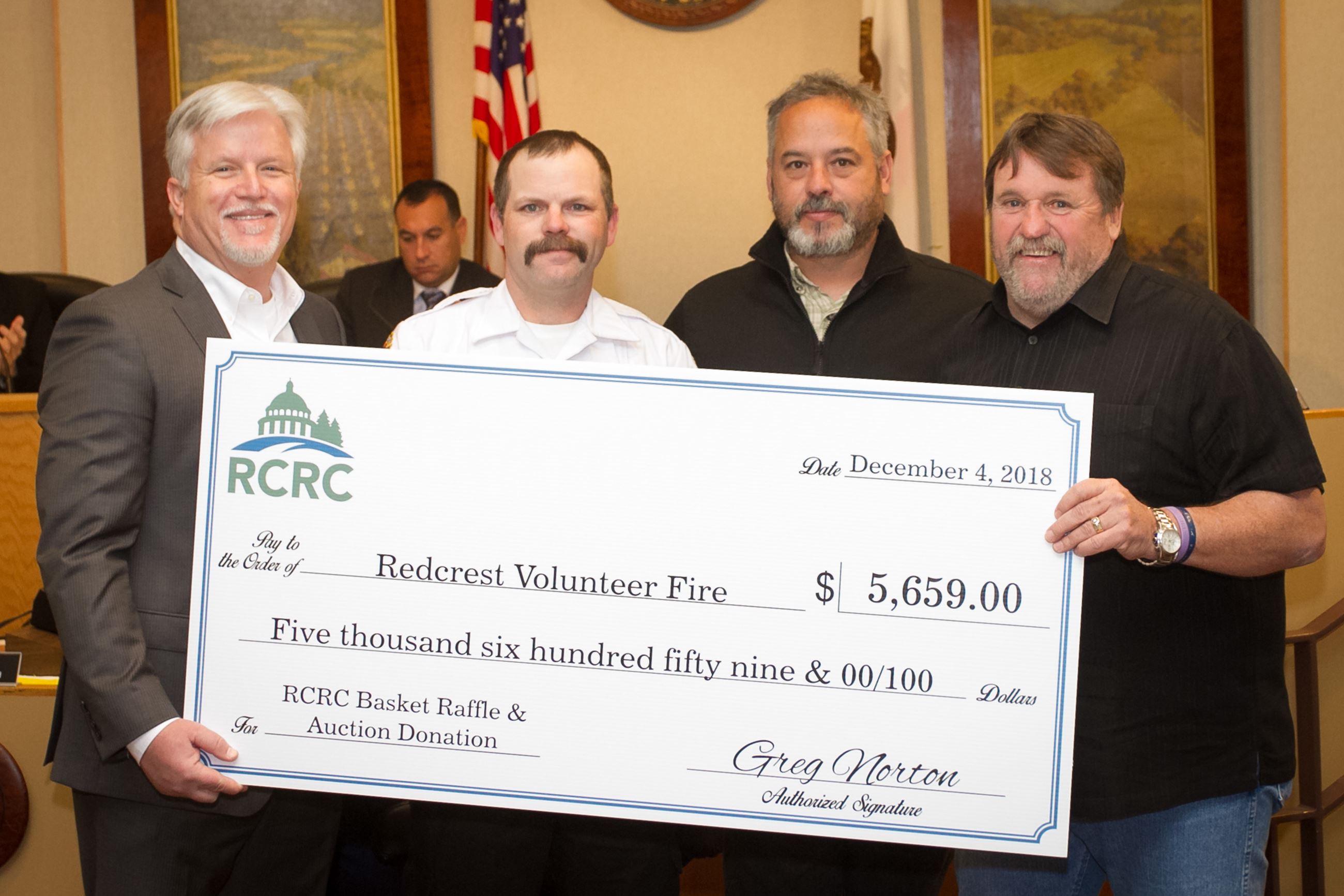 Supervisor Rex Bohn, right, and RCRC Chief Executive Officer Greg Norton, left, present the Redcrest
