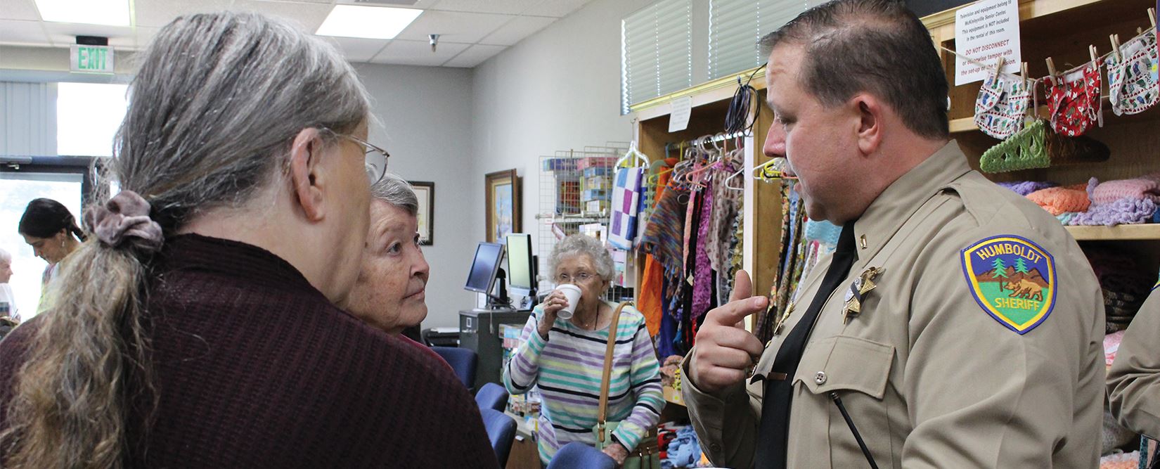 Sheriff’s Captain speaks with two women during a Coffee with the Cops event