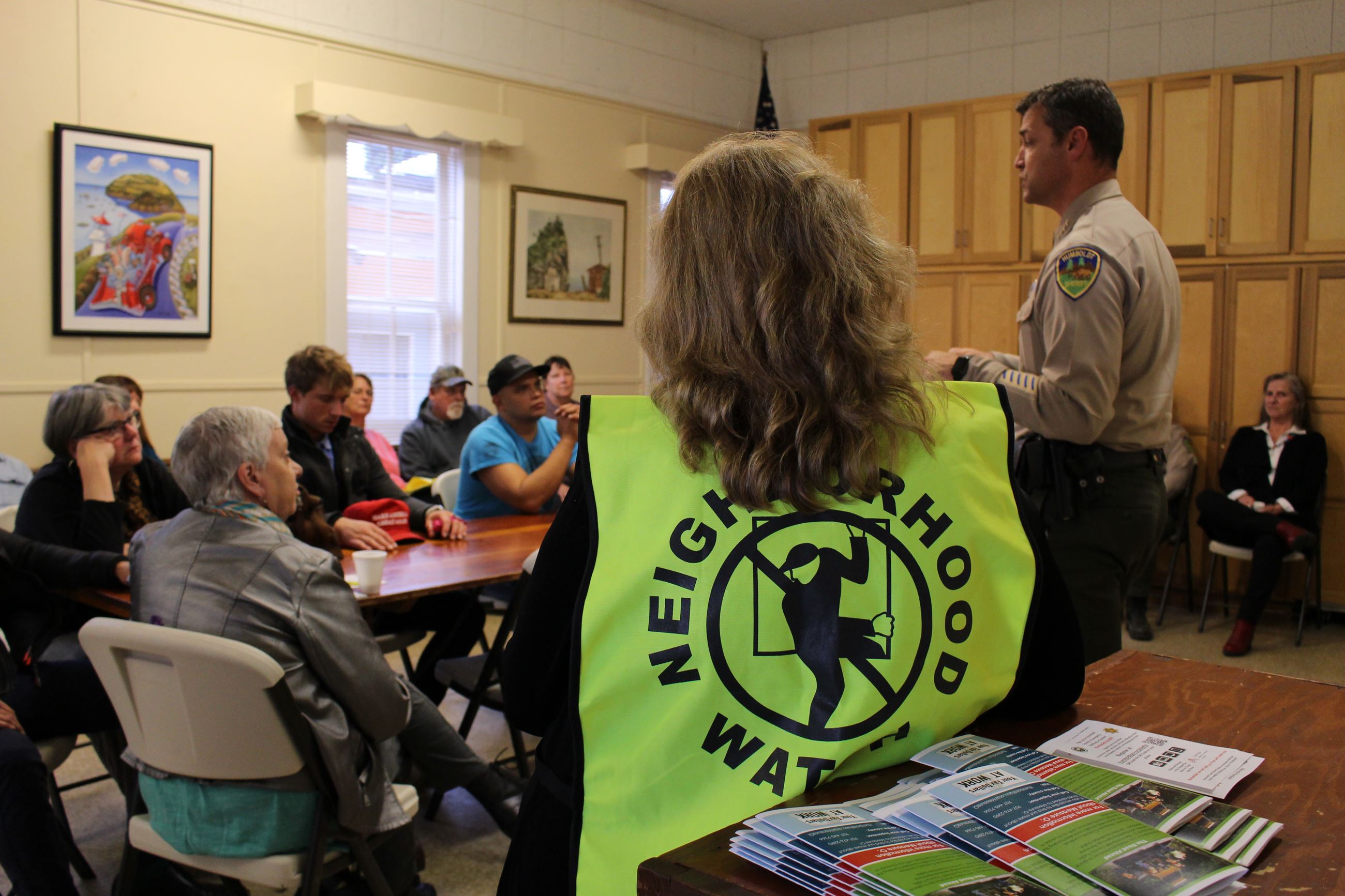 A Neighborhood Watch volunteer with a vest on