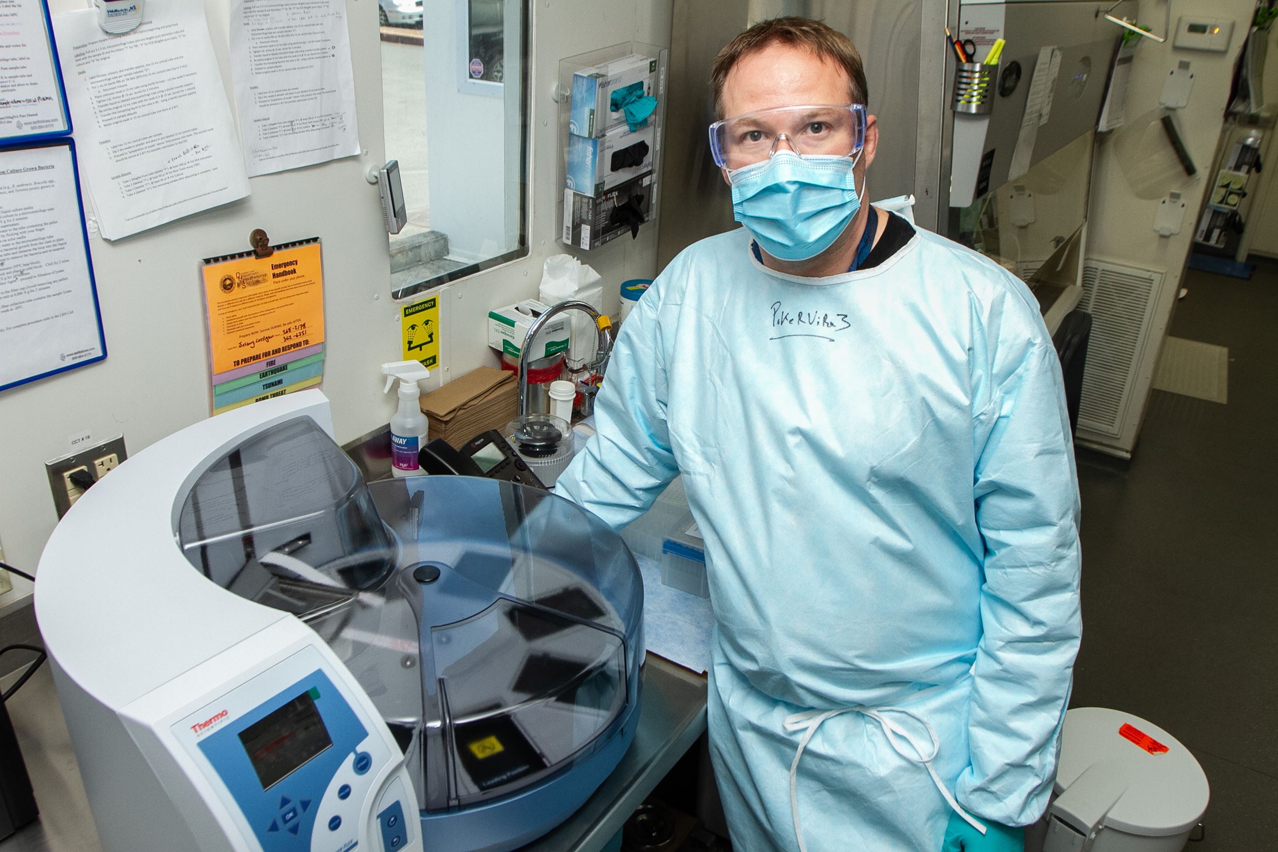 Public Health Laboratory Manager Jeremy Corrigan with the delivered Kingfisher Flex RNA extractor
