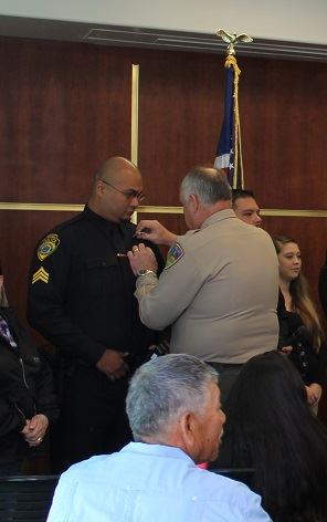 Sheriff Downey pinning HVTPD Ofc Ruiz
